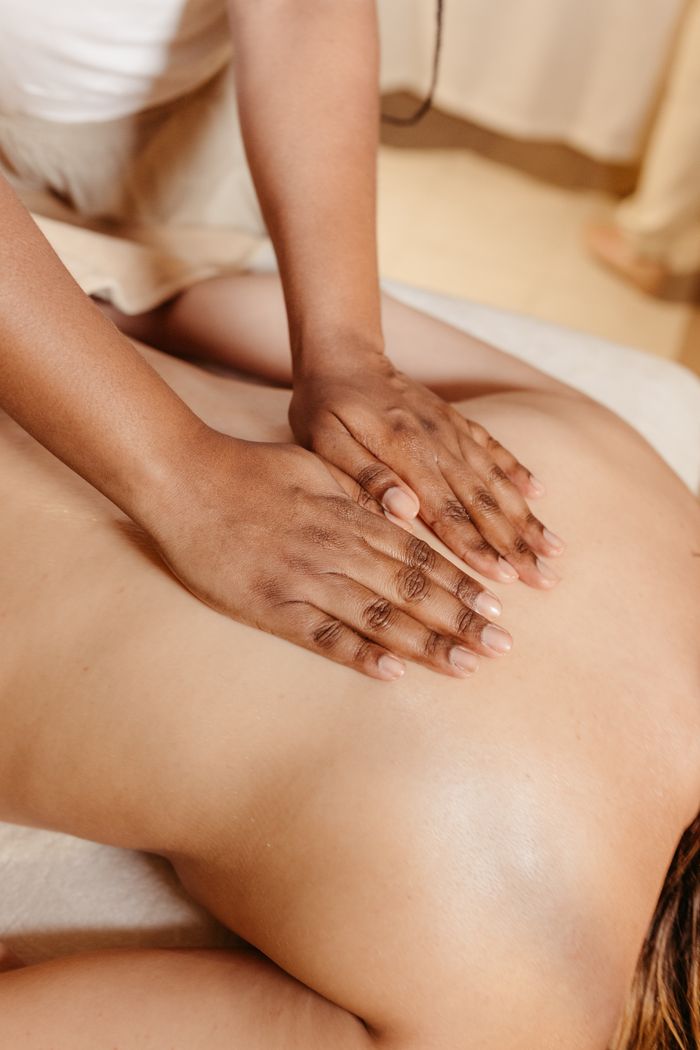 social-feed-img-04 Close-up of a relaxing spa massage with a therapist massaging a woman's back.