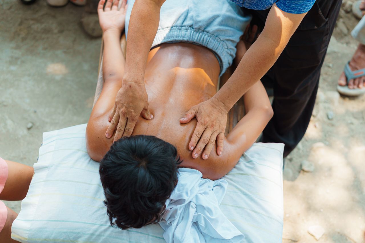 about-img A relaxing outdoor back massage session providing stress relief and wellness benefits.