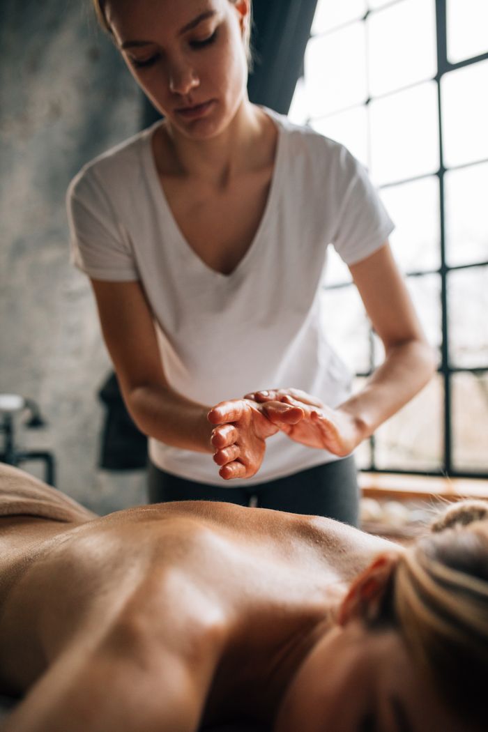 quality-assurance-01 A woman receives a calming massage in a serene spa setting, promoting relaxation and wellness.