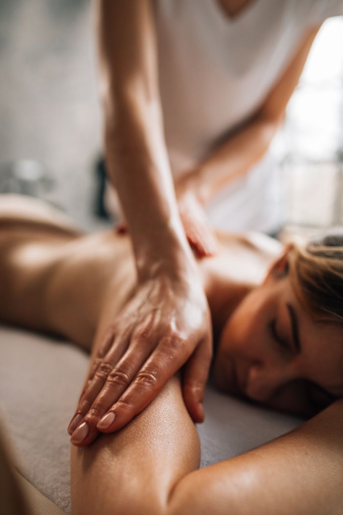 social-feed-img-05 A woman enjoying a relaxing massage in a serene spa environment, promoting self-care and wellness.